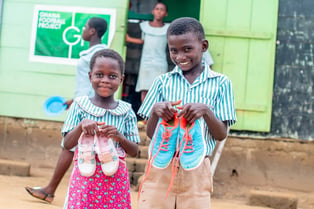 Children recieving shoes